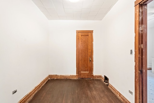 unfurnished room with dark wood-type flooring