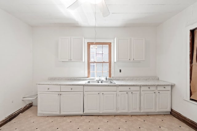 kitchen with sink and white cabinetry