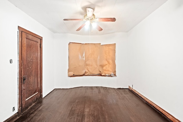 empty room with ceiling fan and dark hardwood / wood-style floors