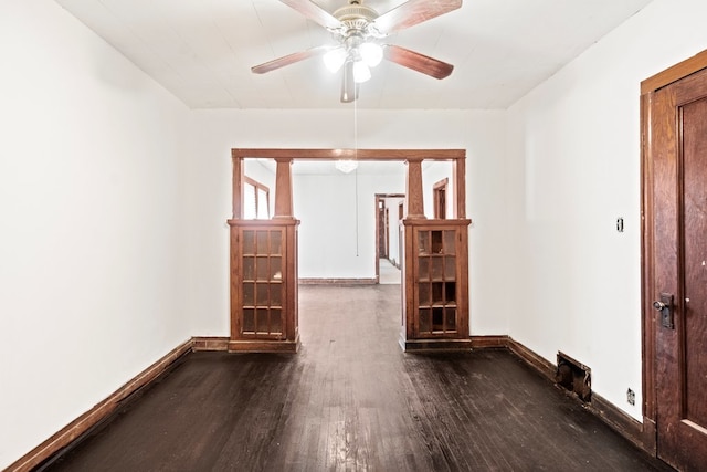 empty room with ceiling fan and dark hardwood / wood-style floors