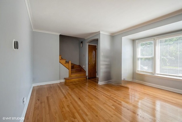 unfurnished room with ornamental molding and light hardwood / wood-style flooring