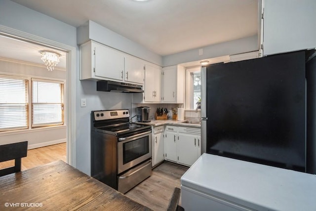 kitchen with a chandelier, stainless steel appliances, light wood-type flooring, sink, and white cabinetry