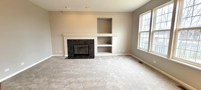 unfurnished living room featuring carpet and a fireplace