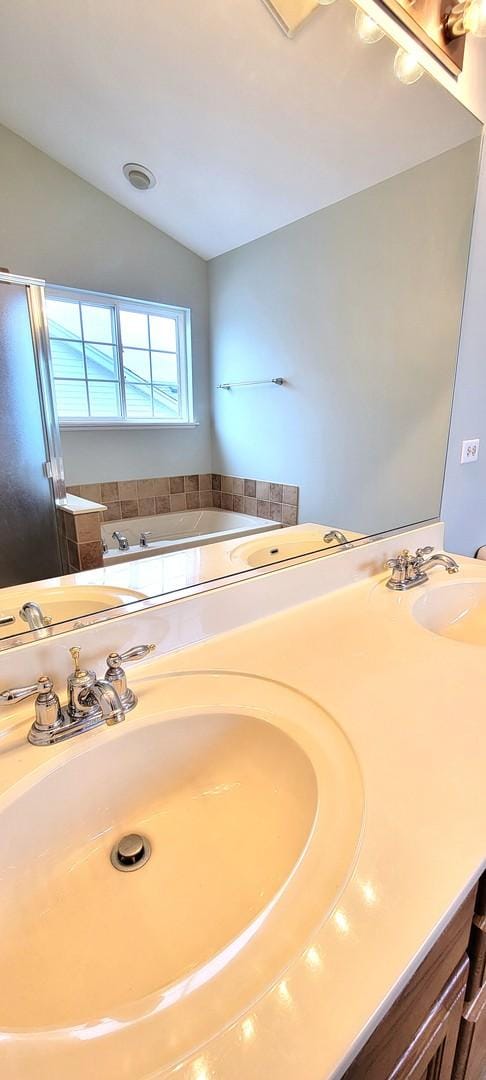 bathroom featuring vaulted ceiling and vanity