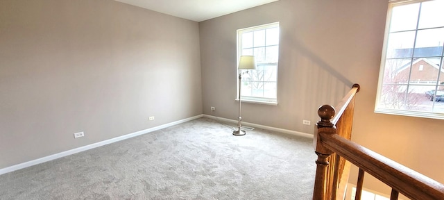 carpeted empty room featuring a wealth of natural light