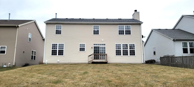 rear view of property featuring a yard