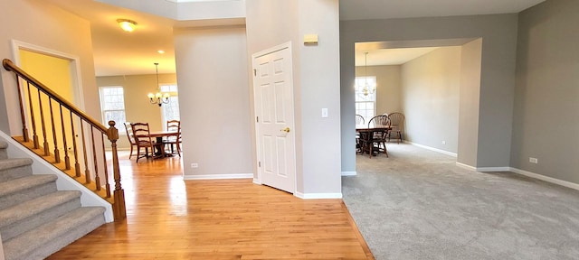 entryway featuring an inviting chandelier and light hardwood / wood-style flooring