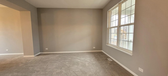 unfurnished room featuring carpet