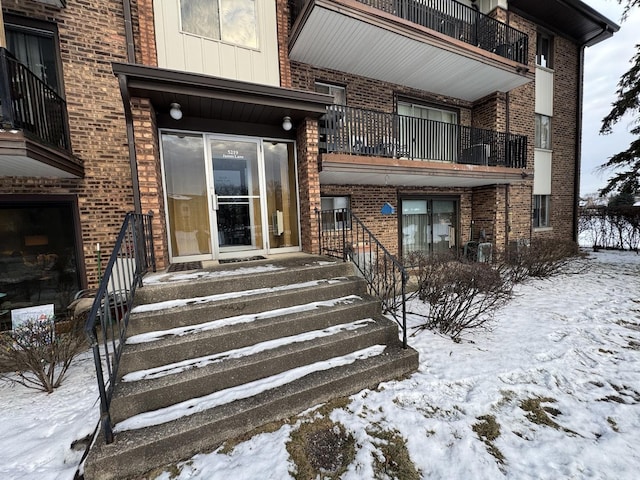 view of snow covered property entrance