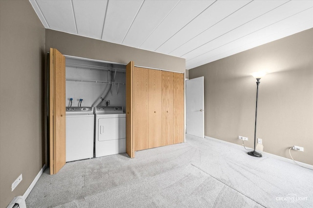 laundry area featuring light colored carpet, a baseboard radiator, and independent washer and dryer