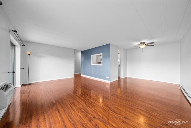 spare room with a baseboard radiator, hardwood / wood-style floors, and ceiling fan