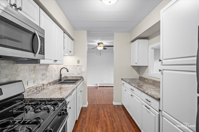 kitchen with white cabinets, range with gas cooktop, light stone countertops, dark hardwood / wood-style flooring, and sink