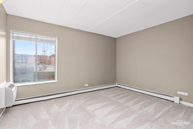 carpeted empty room with baseboard heating