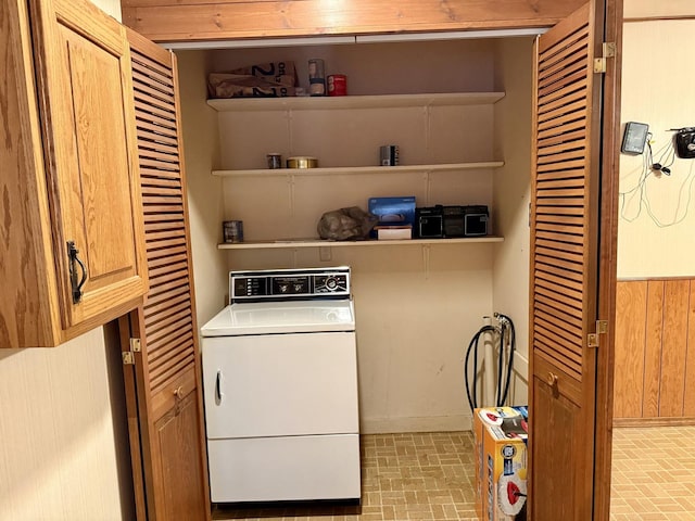 laundry room with washer / dryer and wood walls