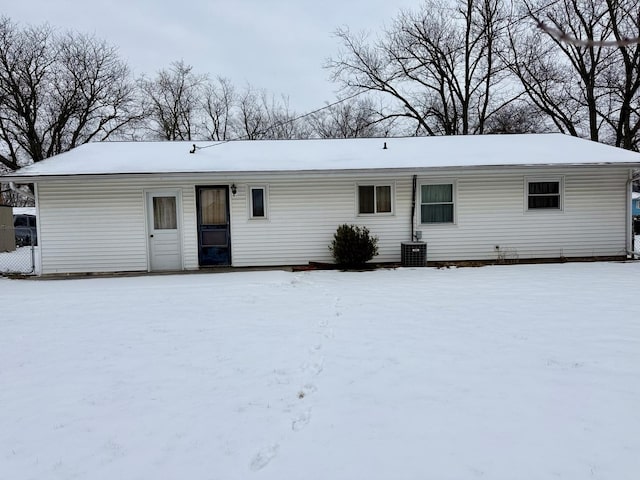 snow covered back of property with central air condition unit