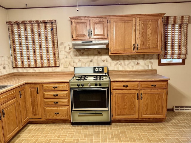 kitchen featuring backsplash, range with gas stovetop, and a healthy amount of sunlight