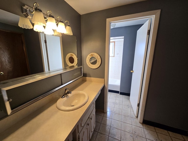 bathroom featuring a notable chandelier, tile patterned flooring, a bath, and vanity