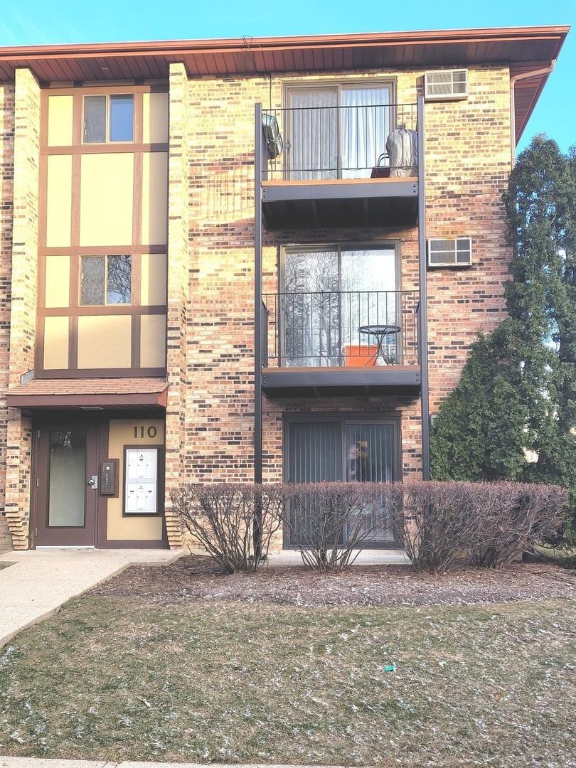 view of building exterior with a wall unit AC