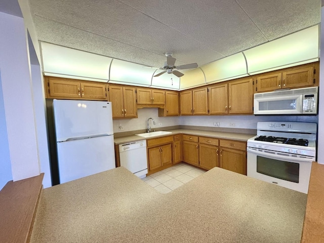 kitchen featuring white appliances, ceiling fan, and sink