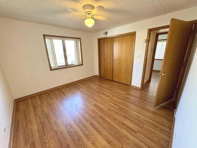 unfurnished bedroom featuring ceiling fan and light wood-type flooring