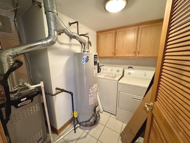 laundry room with washer and dryer, cabinets, water heater, and light tile patterned floors