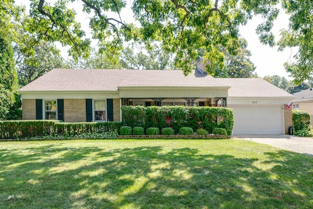 single story home featuring a front yard and a garage