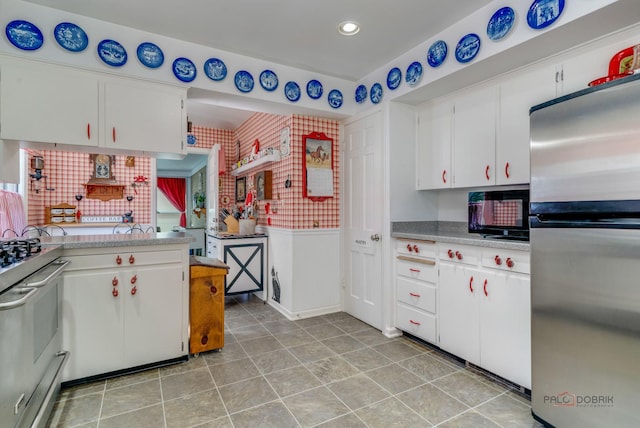 kitchen featuring stainless steel appliances and white cabinets