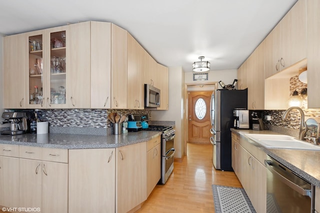 kitchen featuring sink, light brown cabinets, and appliances with stainless steel finishes