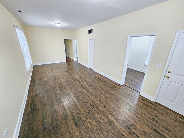 unfurnished room featuring dark wood-type flooring