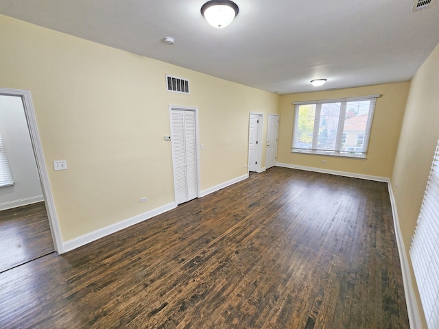 empty room with dark hardwood / wood-style floors