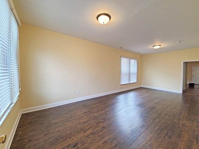 spare room featuring dark wood-type flooring