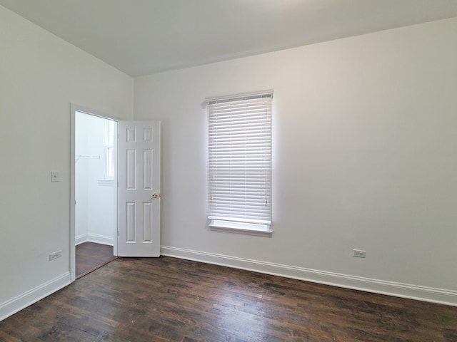 spare room featuring dark wood-type flooring