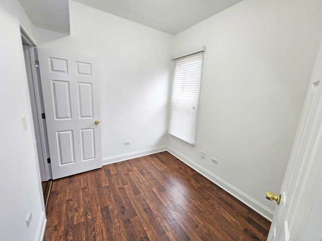 unfurnished bedroom featuring dark hardwood / wood-style floors