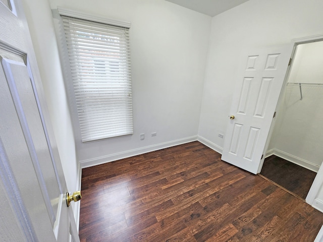 empty room featuring dark hardwood / wood-style flooring