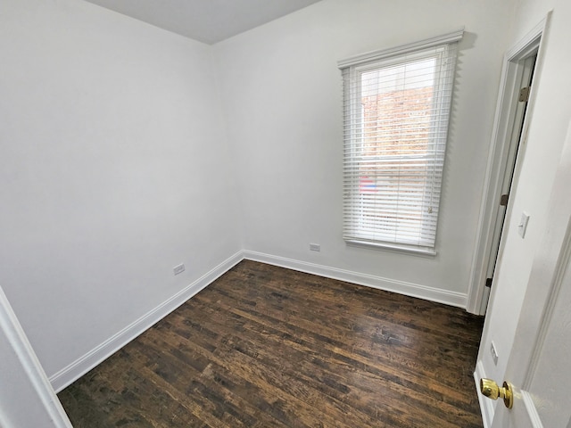 spare room with dark hardwood / wood-style flooring