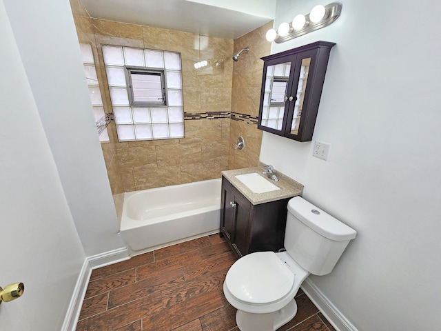 full bathroom featuring toilet, tiled shower / bath combo, and vanity