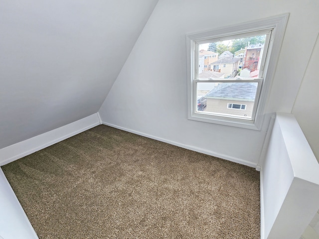 bonus room featuring lofted ceiling and carpet flooring