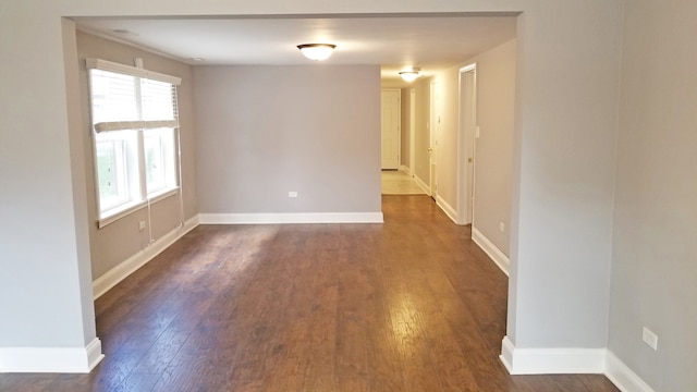 spare room featuring dark hardwood / wood-style flooring