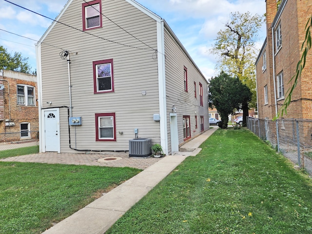 view of front of house featuring a front yard and cooling unit