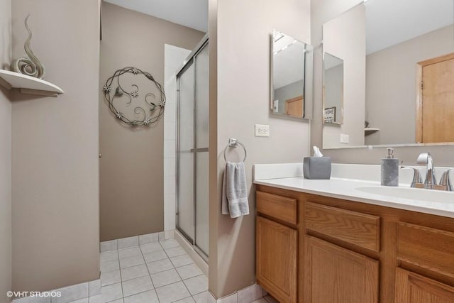 bathroom featuring vanity, tile patterned flooring, and a shower with door