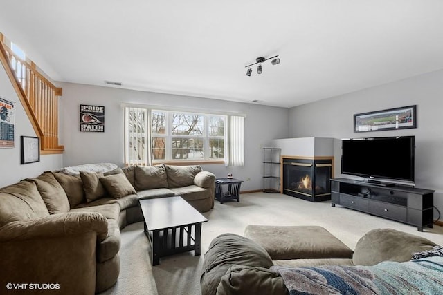 carpeted living room featuring rail lighting