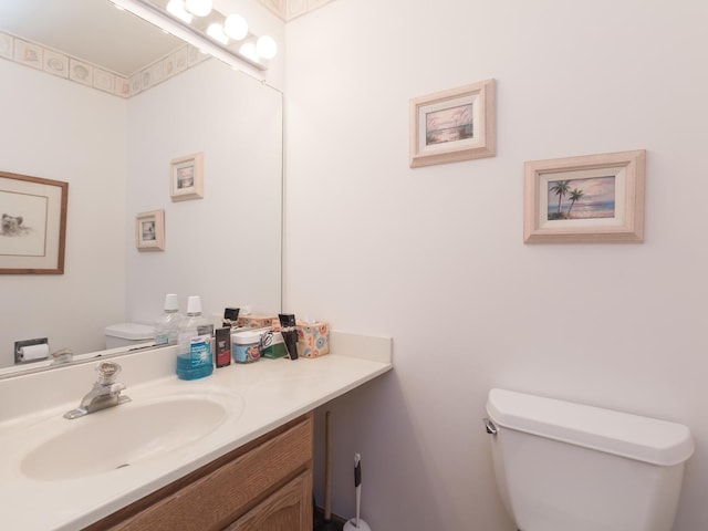 bathroom with toilet and vanity