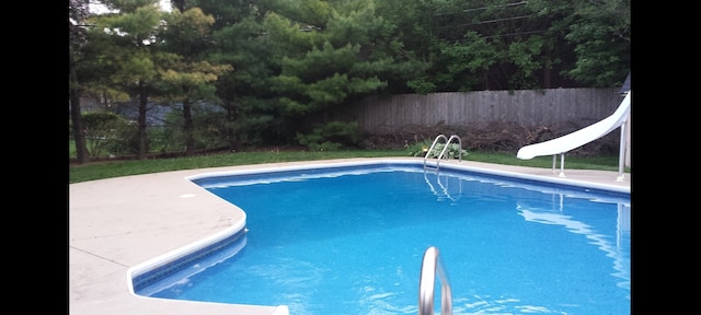 view of pool with a water slide