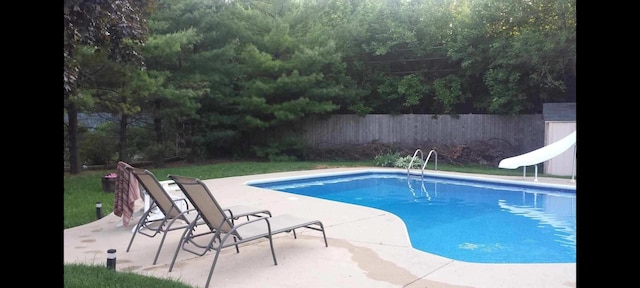 view of swimming pool with a water slide