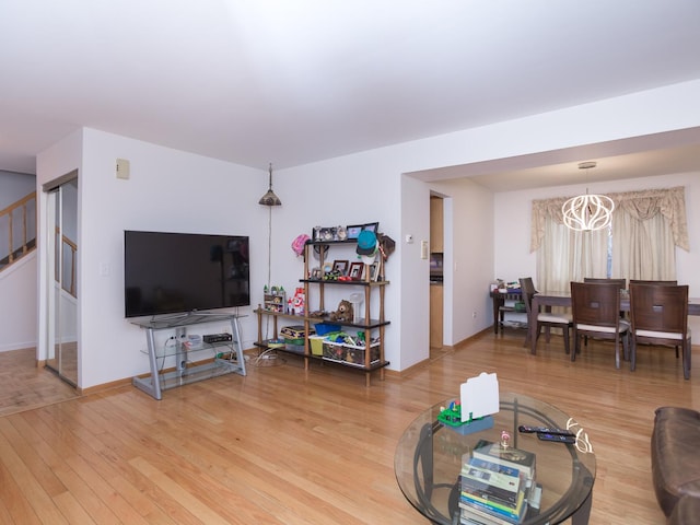 living room with hardwood / wood-style flooring and a notable chandelier