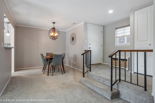 dining area featuring a chandelier, ornamental molding, and light colored carpet