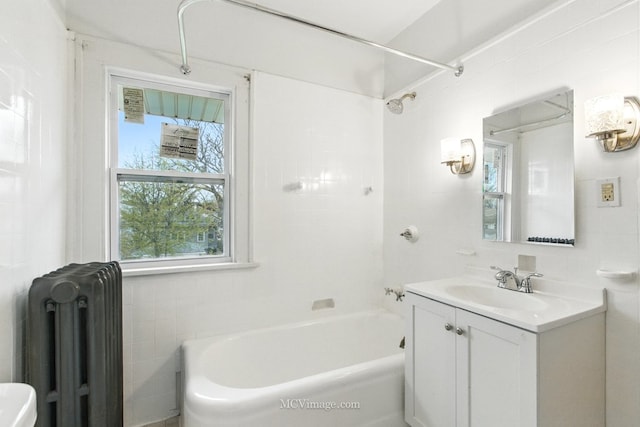 full bathroom with tile walls, radiator,  shower combination, and vanity