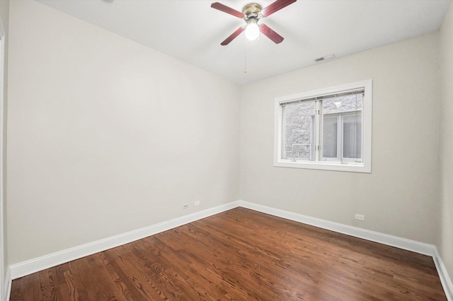 empty room with hardwood / wood-style floors and ceiling fan