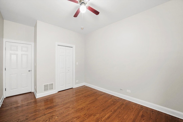 unfurnished bedroom featuring ceiling fan and dark hardwood / wood-style floors