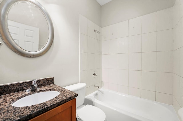 full bathroom with vanity, tiled shower / bath combo, and toilet